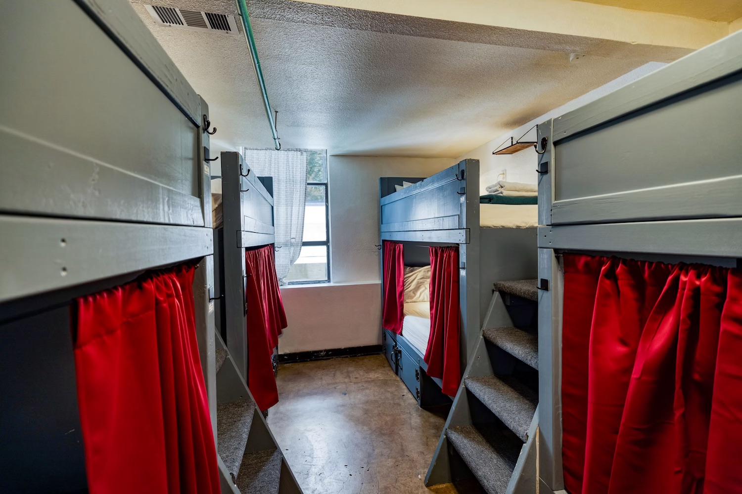 Dorm corridor between bunk bed rows