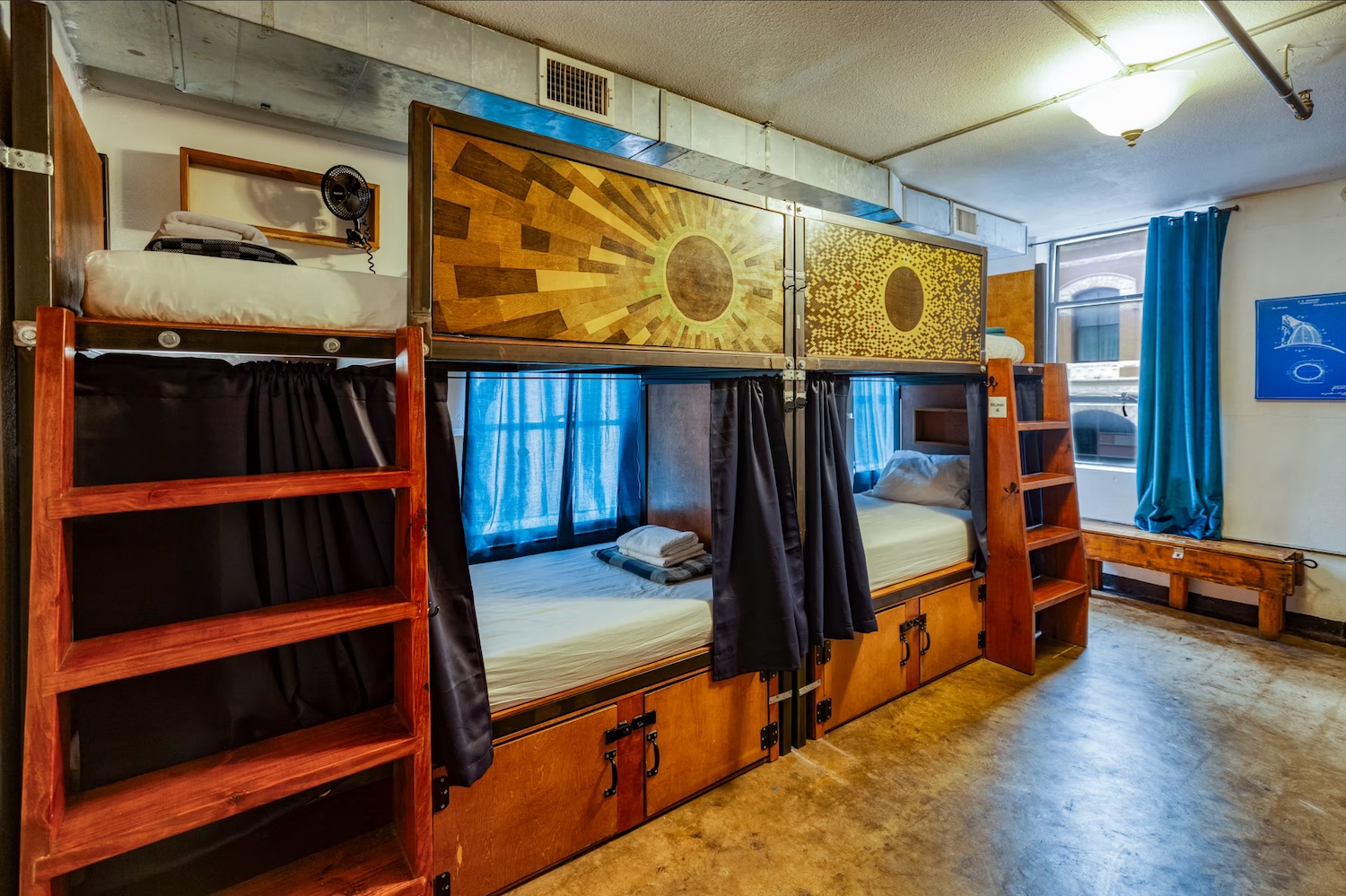 Wide view of dorm room with custom bunk beds and natural light