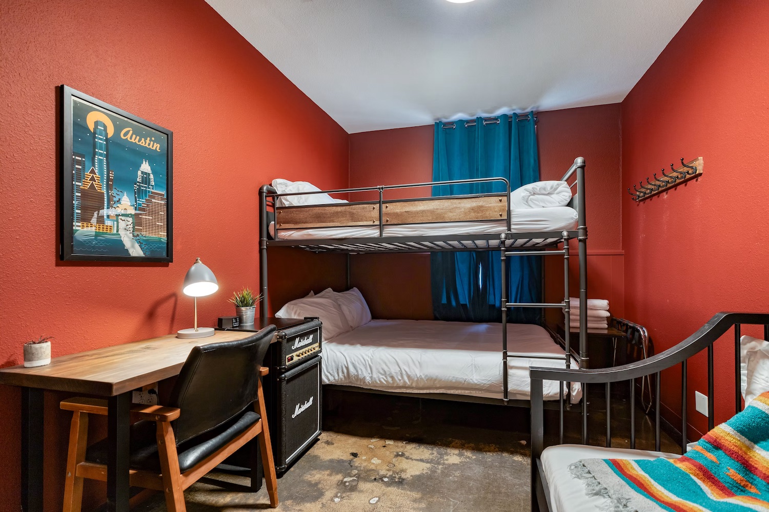 Full private room layout from doorway with queen bed and warm lighting